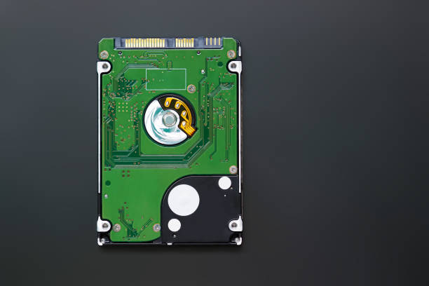 istock Green 2.5 inch hard disk drive from the computer, hdd isolated on dark background, top view. Part of computer pc, laptop 1347283770