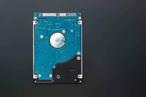 istock Light blue 2.5 inch hard disk drive from the computer, hdd isolated on dark background, top view. Part of computer pc, laptop 1347283818