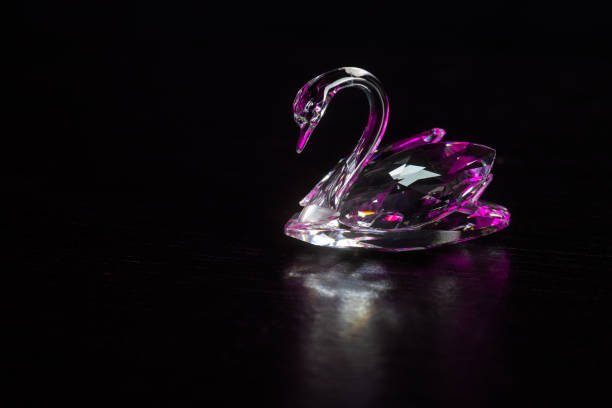 The surface (black wood) simulates a lake, and the crystal swan is \