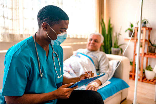 istock Health visitor and senior man during home visit 1347285397