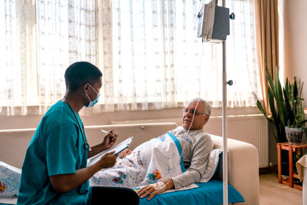 istock Health visitor and senior man during home visit 1347285706