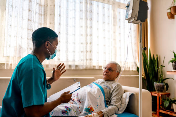 istock Health visitor and senior man during home visit 1347286480
