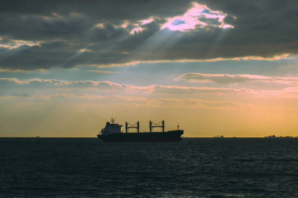 istock A cargo ship on the sea at sunset 1347288223