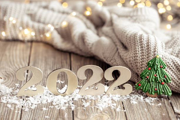istock Cozy holiday composition with the numbers 2022 on a blurred background in bokeh. 1347292543