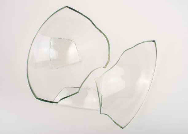 istock Broken glass pieces on white background. Close up, top view. 1347292626