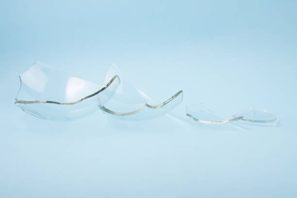 istock Broken glass pieces on pastel blue background. 1347292648