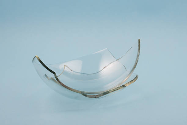 istock Broken glass pieces on pastel blue background. 1347292720