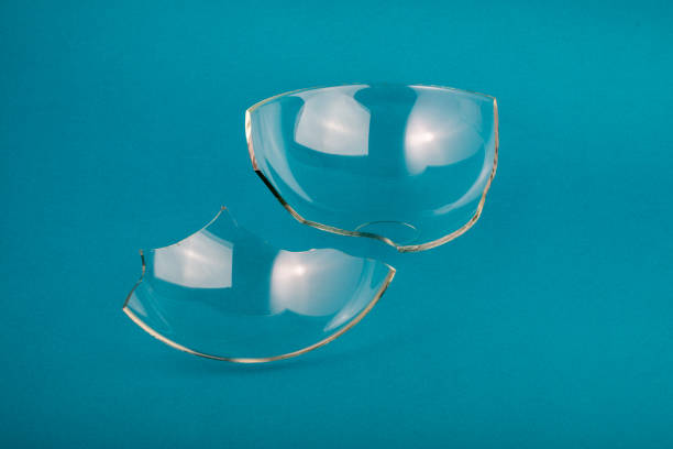 istock Broken glass pieces on pastel blue green background. 1347292749