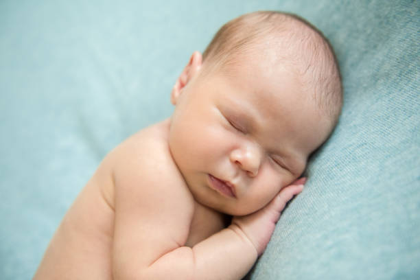 istock Newborn baby sleeping peacefully naked 1347292769