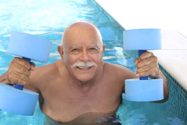 istock Pensioner working out in swimming pool 1347294245