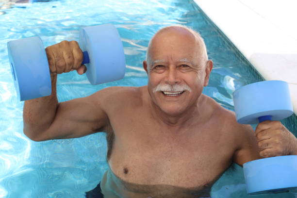 istock Pensioner working out in swimming pool 1347294247