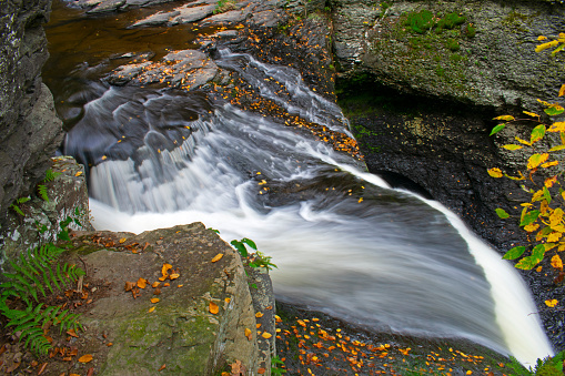 Dingmans Falls in Dingmans Ferry, Pennsylvania, on a mid-autumn afternoon, viewed from the top with long exposure blur