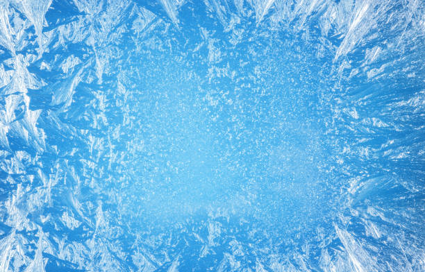 Frosty patterns on the edge of a frozen window. Frosty patterns on the edge of a frozen window. blue condensation stock pictures, royalty-free photos & images