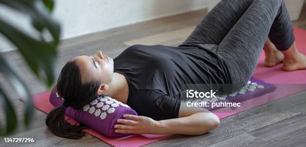 Young Woman On Acupressure Mat In Home Acupuncture Massage Stock Photo - Download Image Now