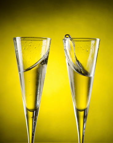 Celebration toast with champagne on yellow background