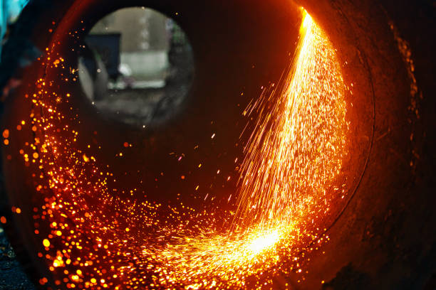 istock Cut a metal pipe of large diameter and sparks fly 1347298491