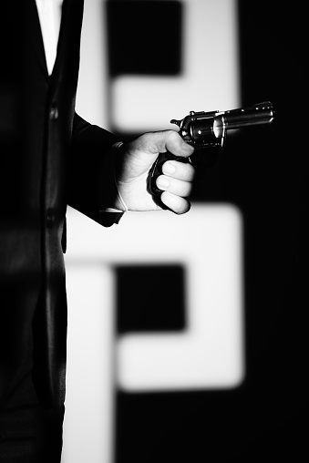 Detective male spy holding pistol gun crime thriller book cover design photo.