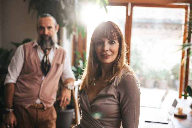 A couple of business people posing in their home studio in a break from work.