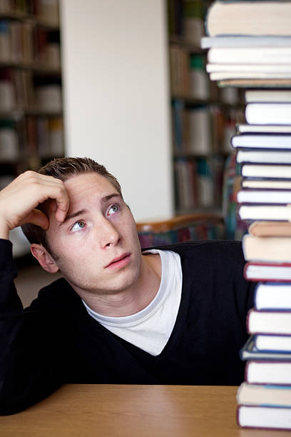 istock Stressed Student Looks At Book Pile 134730025