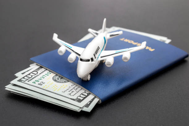airplane toy with passports and money on black background. top view. air trip and vacation. - fighter plane aerospace industry air air vehicle imagens e fotografias de stock