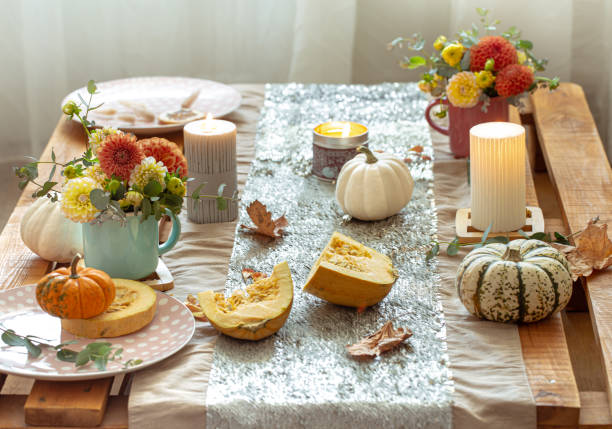 istock Festive table setting with pumpkins and chrysanthemum flowers. 1347300992