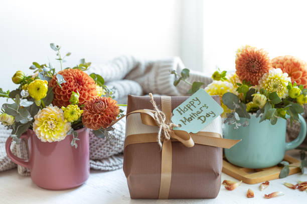 istock Spring composition for mother's day with a gift and chrysanthemum flowers. 1347300994