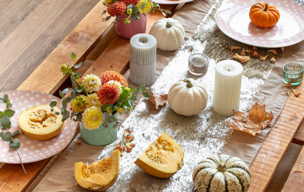 istock Festive table setting with pumpkins and chrysanthemum flowers. 1347300996