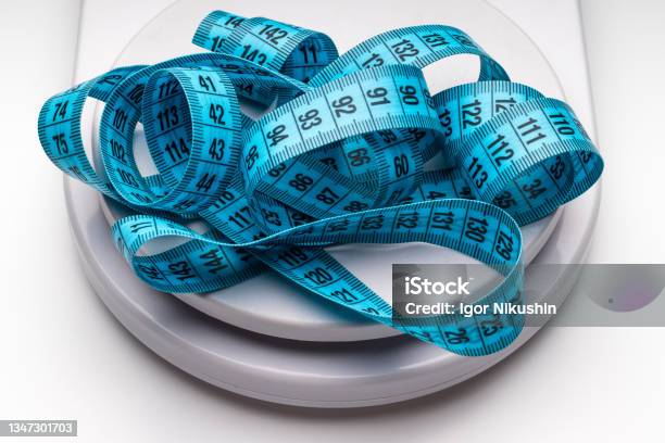 Blue Measuring Tape And Weight Scales Stock Photo - Download Image Now - Obesity, Balance, Dieting