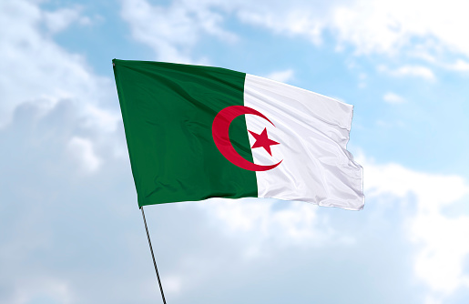 Flag of Algeria in front of the blue sky