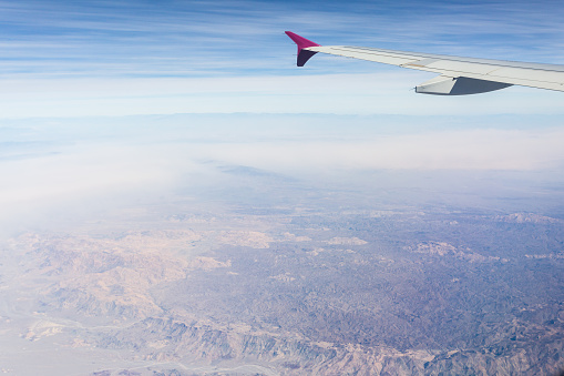 Aerial view of the desert from the airplane porthole. Travel concept