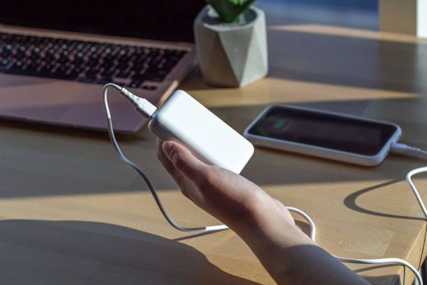 istock Small white power bank in a woman's hand. 1347304496