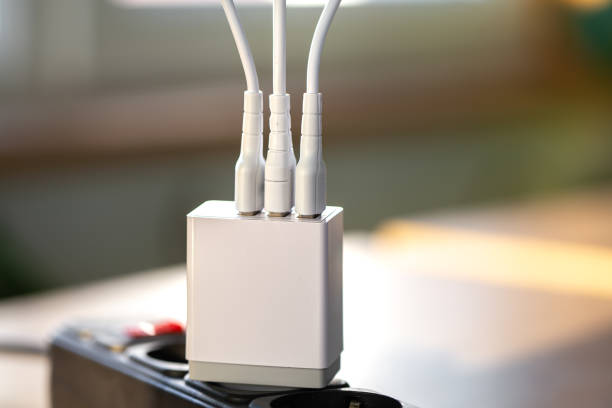 istock White USB charging for gadgets on a blurred background of the room, close-up. 1347304513
