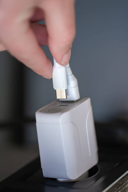 istock White USB charging for gadgets on a blurred background of the room, close-up. 1347304519