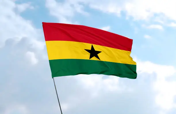 Flag of Ghana in front of the blue sky
