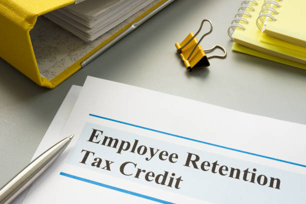 employee retention tax credit papers and folder. - tax imagens e fotografias de stock