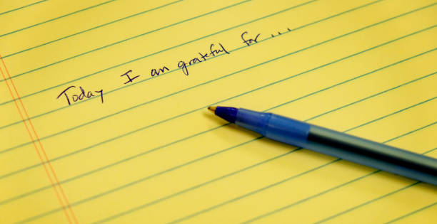 Gratitude notebook with pen writing today I am grateful for stock photo