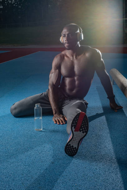 istock Male athlete stretching his legs before exercise 1347305985