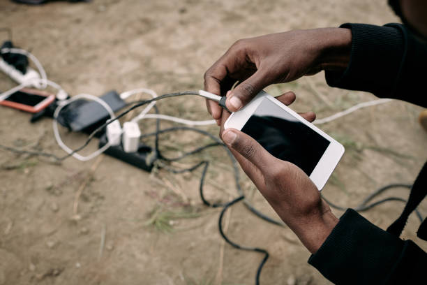 Hand of male migrant hoding smartphone while going to call or record voice message
