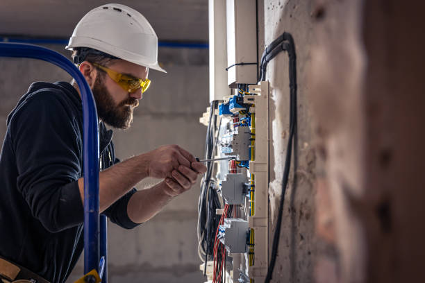 istock A male electrician works in a switchboard with an electrical connecting cable. 1347307606
