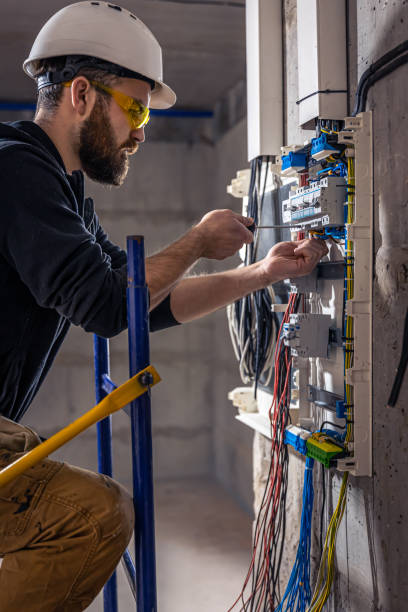 istock A male electrician works in a switchboard with an electrical connecting cable. 1347307617