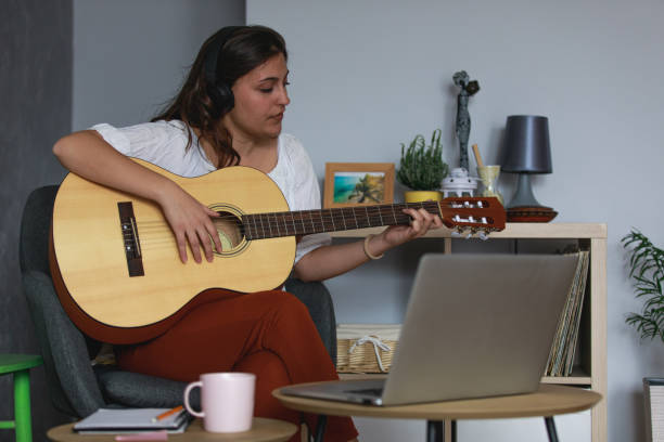 istock Video conferencing with friends and playing music together 1347314123
