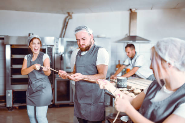 istock Friends In Bakery Having Pulling Competition With Rope Made Of Dough 1347314816