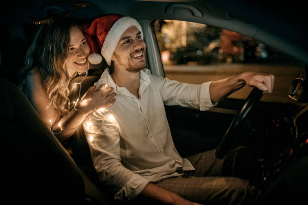 Get ready for New Year's Eve Photo of young couple are ready for New Year's Eve. couple driving at night stock pictures, royalty-free photos & images