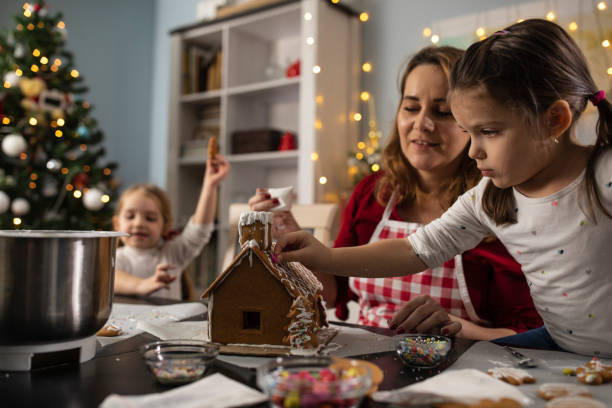 istock Having fun decorating a gingerbread house for Christmas 1347317981