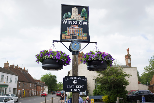 Winslow, UK - June 25, 2021. Winslow traditional market town sign, awarded best kept town in Buckinghamshire. Best rural countryside towns in England, UK