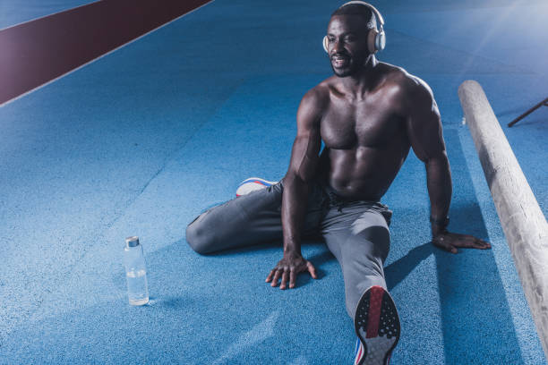 istock Male athlete stretching before exercise 1347318987