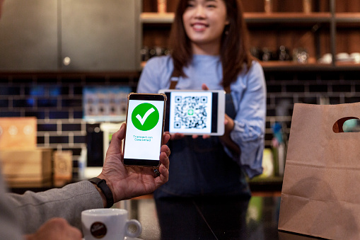 Customer using mobile phone for payment at cafe restaurant, cashless QR code technology and money transfer concept stock photo...