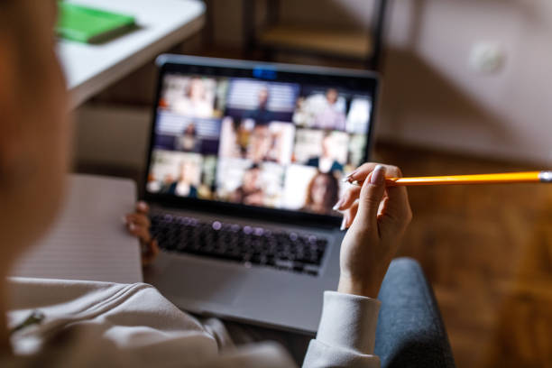 istock Teenage girl on a video call with classmates and professor during e-learning 1347321533