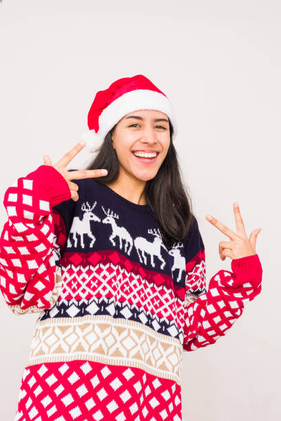 Christmas ugly sweater. Latin venezuelan woman wearing a fashion woolen xmas style stock photo