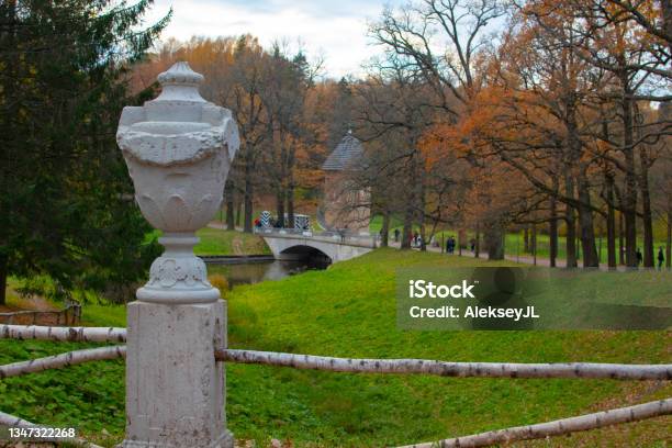 An Old Flowerpot With A Tower And A Bridge In The Background Autumn Park Stock Photo - Download Image Now